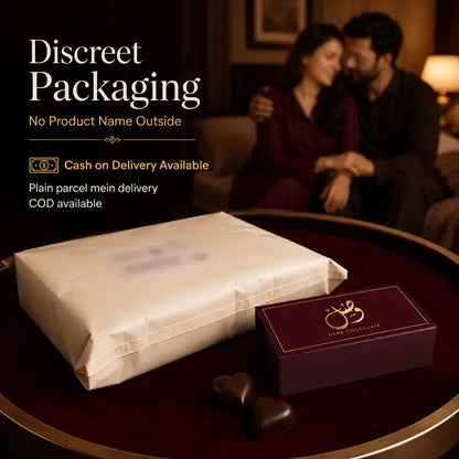 A wrapped gift package and a small dark chocolate box with a gold ring logo sit on a round table in a dimly lit indoor setting. A blurred couple is seated in the background, and promotional text on the left reads 'Discreet Packaging' with delivery offer details.